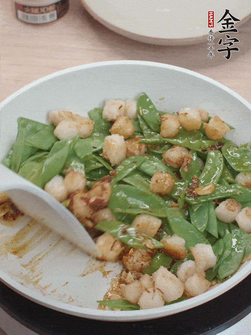 下甜豆莢、鮮貝輕輕翻炒均勻。