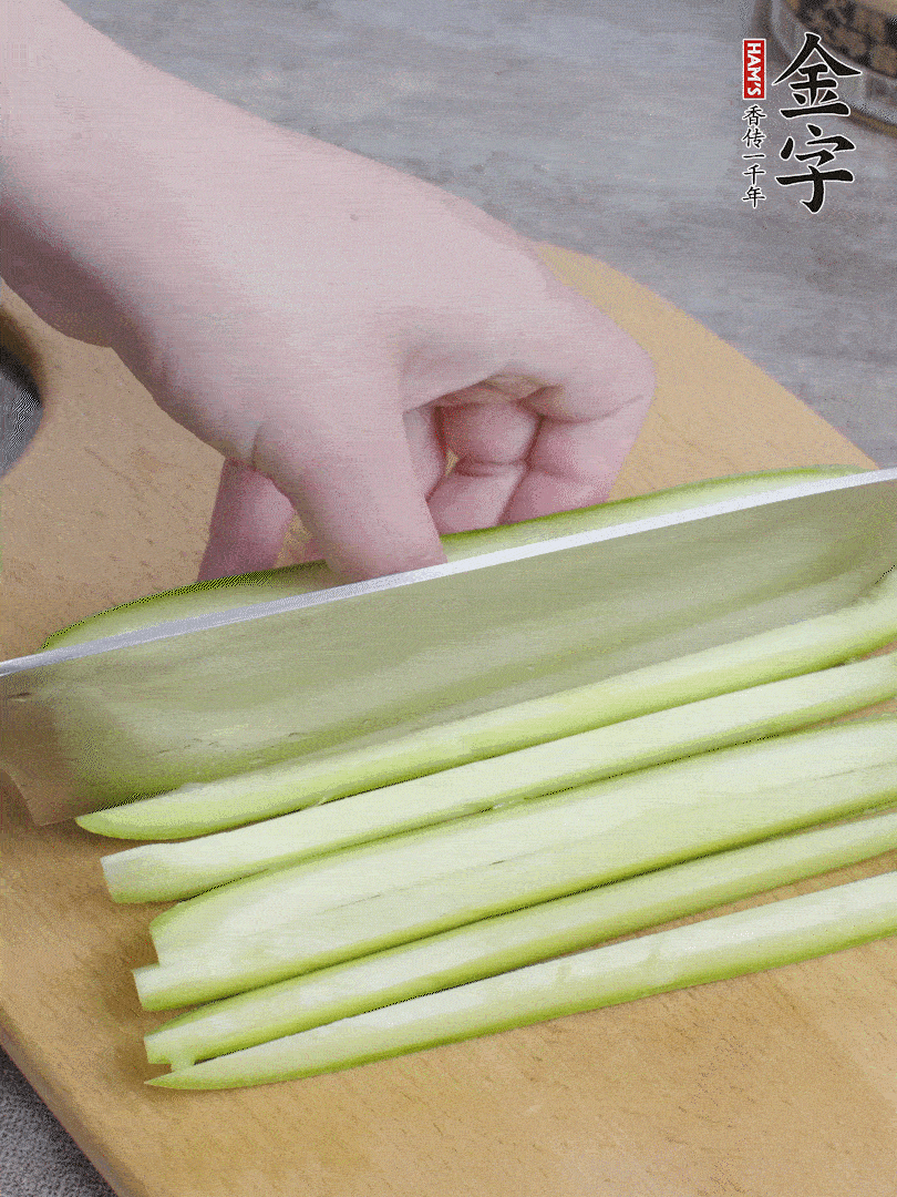 西葫蘆對(duì)半切，去瓤切條。