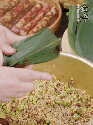 粽葉往下折，完全蓋住，兩側捏緊。